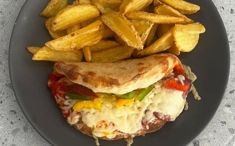Aero: Paninifocaccia bread, salami peperoni, gouda, tomato-pepper sauce, peppers, served with french fries