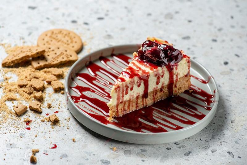 Cheesecake: mixed berry jam and cherry syrup