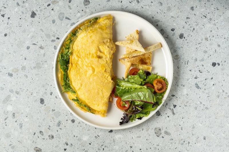 Eggstrordinary: Omelet with kefalotiri cheese, turkey, pepper, mushrooms and yogurt sauce with pesto