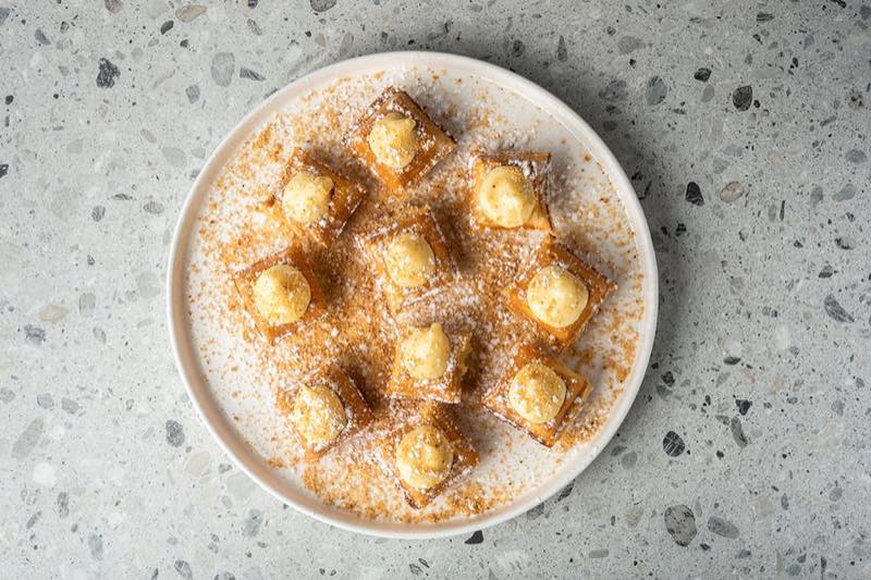 Milleufeille: pastry cream, crushed biscuits and powdered sugar