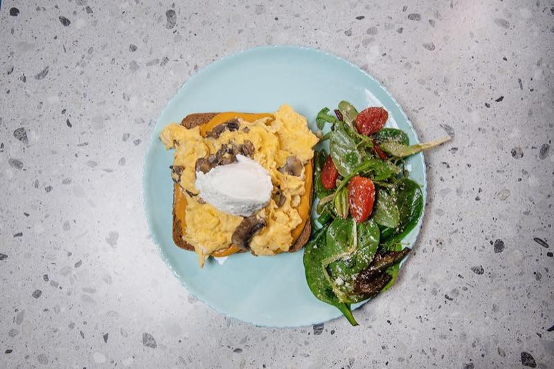 Scrambled Eggs: Scrambled eggs on a slice of sourdough bread, bacon, mushrooms, feta mousse and sweet potato puree
